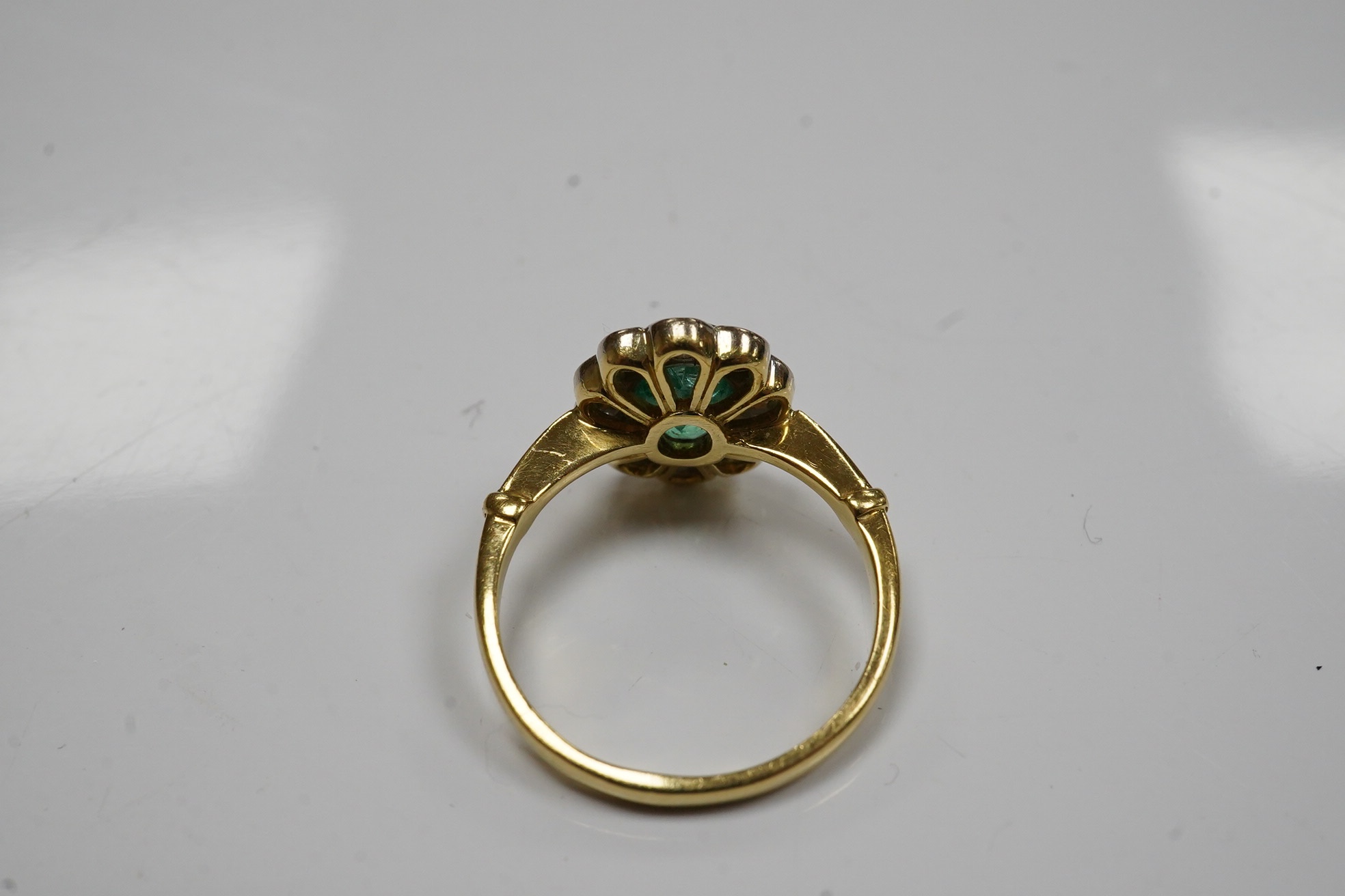 A modern 18ct gold, emerald and diamond set oval cluster ring, size L, gross weight 3.5 grams. Condition - poor to fair